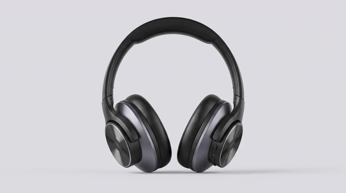 The headphones in black, standing upright on a light grey background